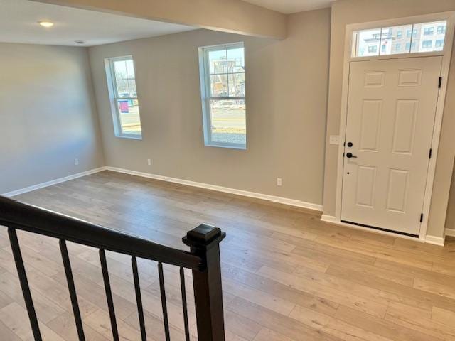 entryway with light wood-style floors and baseboards