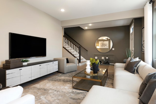 living area featuring wood finished floors, recessed lighting, and stairs