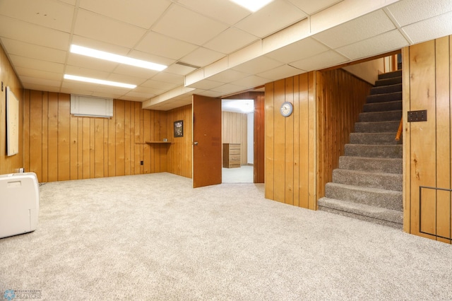929 16th St N, Moorhead, MN 56560 - finished below grade area with carpet, stairway, wooden walls, and a paneled ceiling