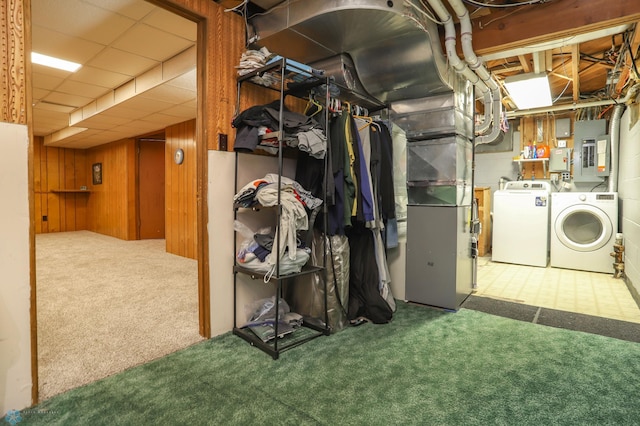 929 16th St N, Moorhead, MN 56560 - below grade area featuring washer and clothes dryer, carpet flooring, electric panel, wood walls, and heating unit