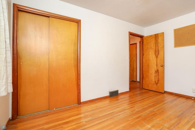 929 16th St N, Moorhead, MN 56560 - unfurnished bedroom featuring light wood-type flooring, baseboards, and a closet