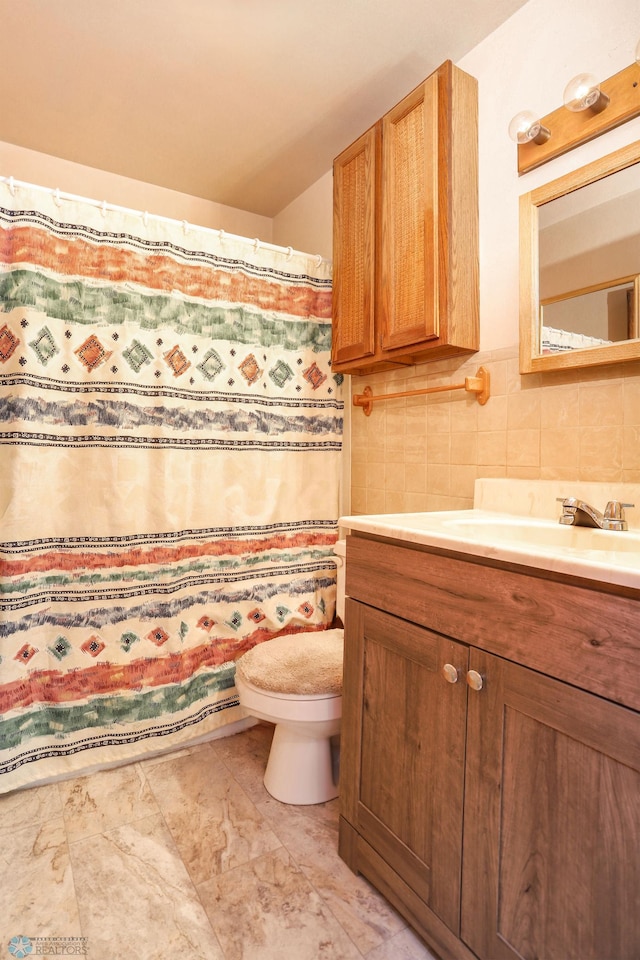 929 16th St N, Moorhead, MN 56560 - bathroom featuring vanity, toilet, tasteful backsplash, and a shower with shower curtain