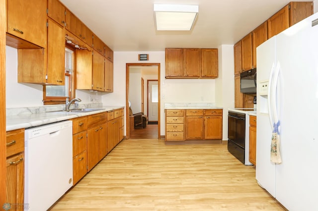 929 16th St N, Moorhead, MN 56560 - kitchen with white appliances, a sink, light wood finished floors, and light countertops