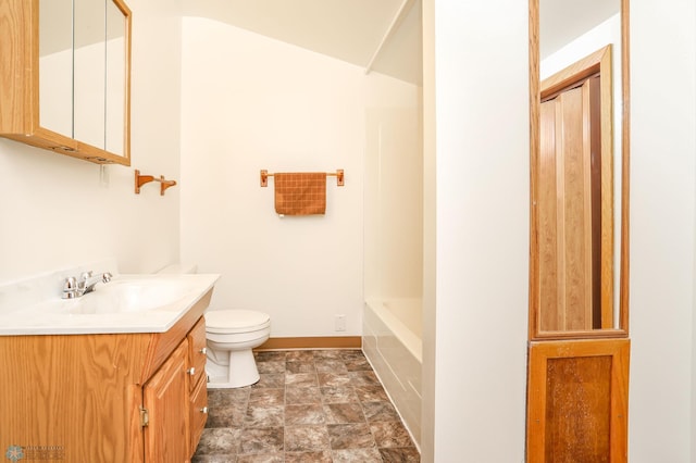 929 16th St N, Moorhead, MN 56560 - full bathroom with vanity, toilet, stone finish floors, and baseboards