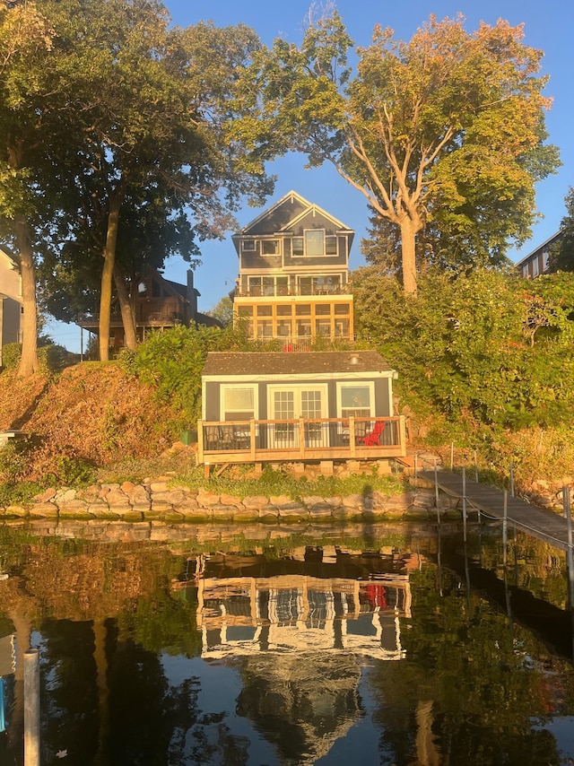 back of house featuring a balcony and a deck with water view