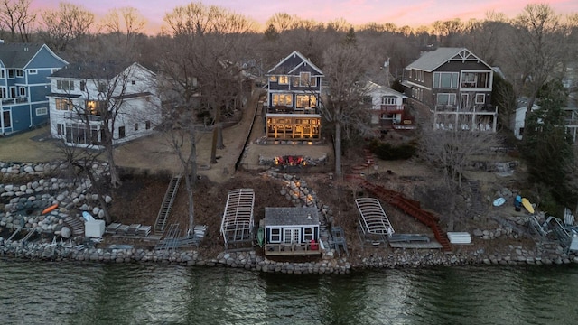 aerial view at dusk with a water view