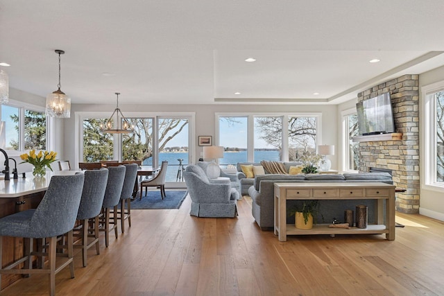 living area with recessed lighting, a notable chandelier, and light wood-type flooring