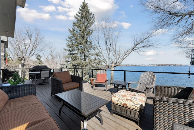 wooden deck with grilling area and a water view