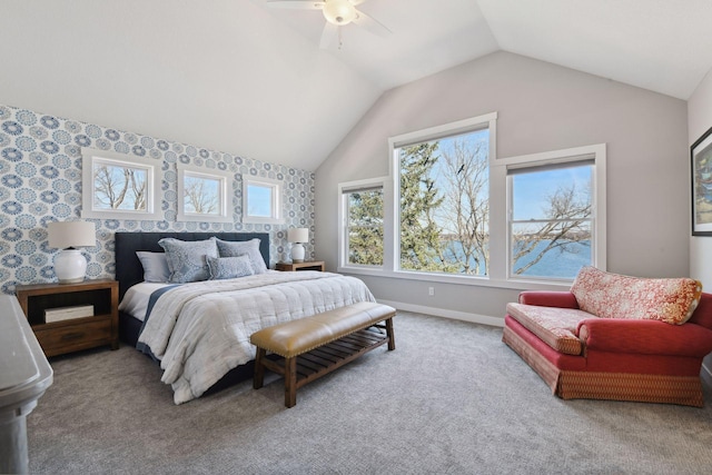 carpeted bedroom with baseboards, a ceiling fan, and vaulted ceiling