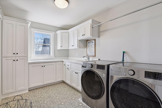 clothes washing area featuring independent washer and dryer, light floors, a sink, and cabinet space