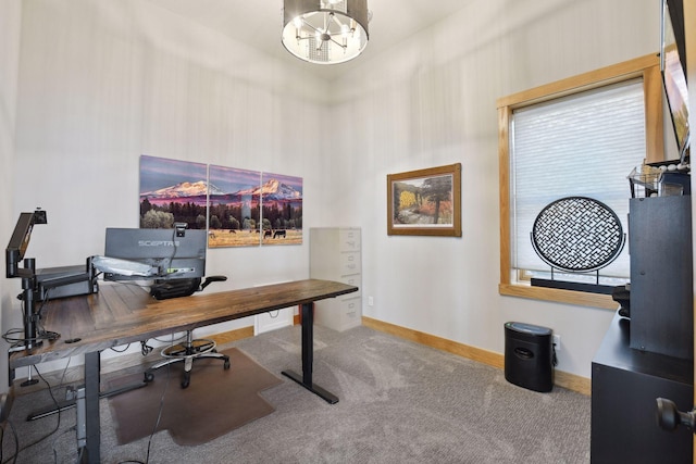 office featuring carpet floors, baseboards, and an inviting chandelier