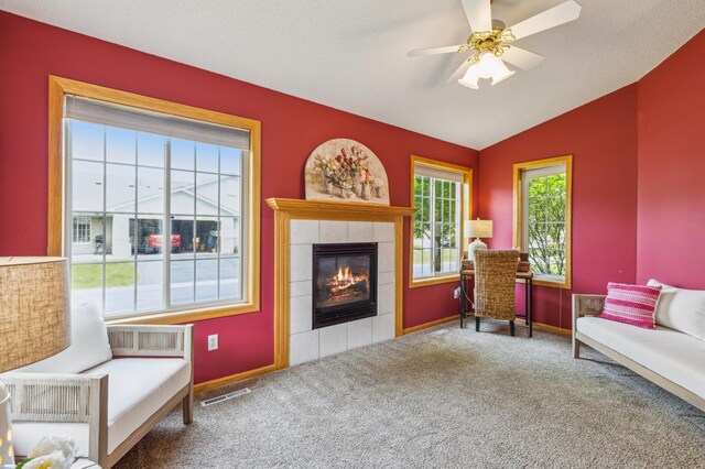 14 3rd St NW, Saint Michael, MN 55376 - living area with a tiled fireplace, carpet, baseboards, lofted ceiling, and a ceiling fan