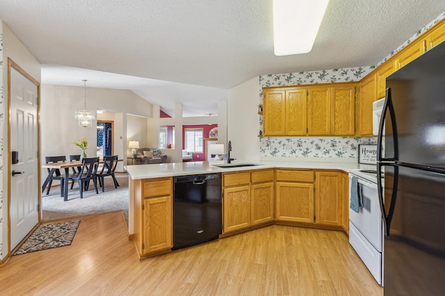 14 3rd St NW, Saint Michael, MN 55376 - kitchen with black appliances, a sink, light wood-style floors, a peninsula, and light countertops
