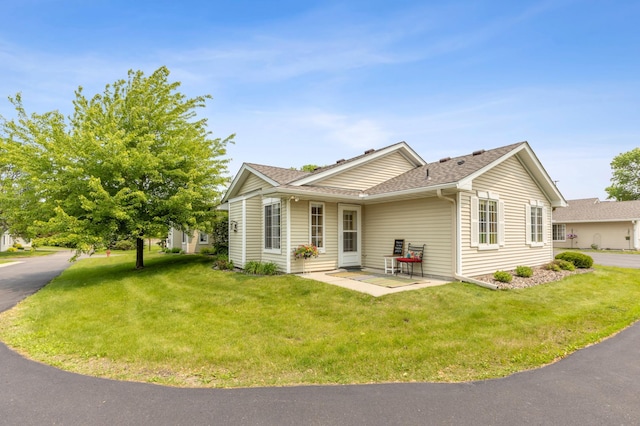 14 3rd St NW, Saint Michael, MN 55376 - view of property exterior with a lawn, a patio, and roof with shingles
