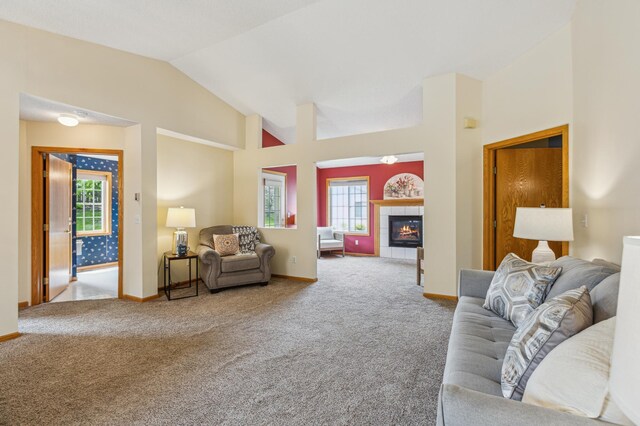 14 3rd St NW, Saint Michael, MN 55376 - living area with carpet floors, baseboards, a tile fireplace, and high vaulted ceiling