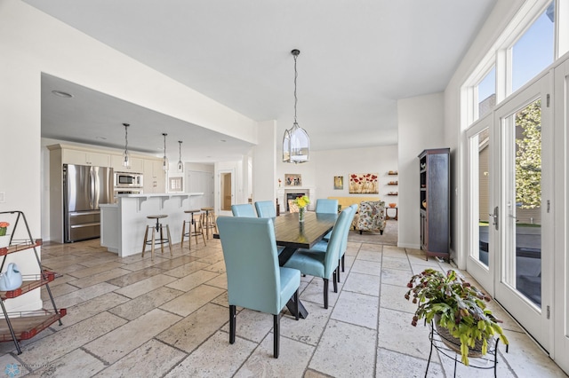dining space with stone tile floors