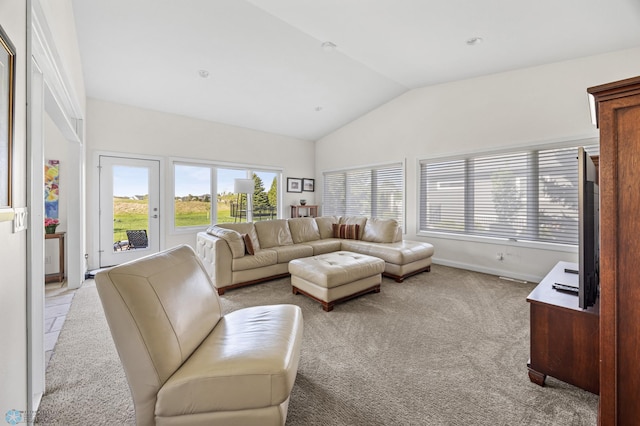 living room featuring vaulted ceiling, light colored carpet, and baseboards