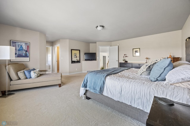 bedroom with light colored carpet and baseboards