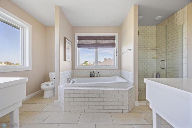 bathroom with a shower stall, a bath, tile patterned flooring, and toilet