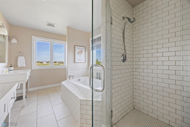 bathroom with a stall shower, tile patterned floors, vanity, and a garden tub
