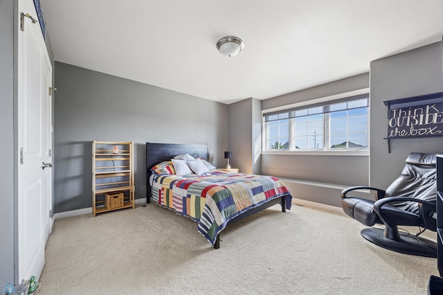 carpeted bedroom featuring baseboards