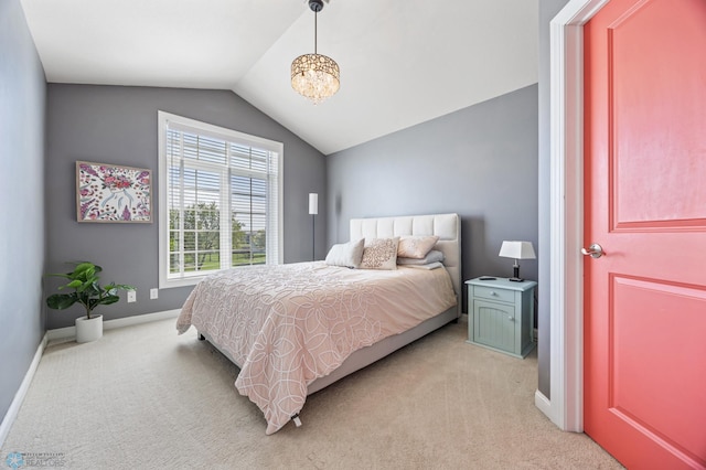 bedroom featuring light carpet, vaulted ceiling, baseboards, and a chandelier