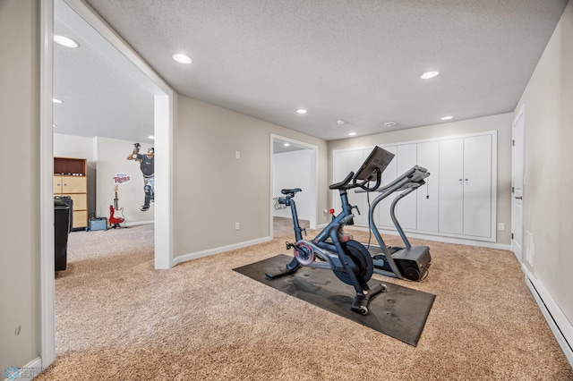 exercise area featuring carpet floors, a textured ceiling, baseboards, recessed lighting, and a baseboard radiator