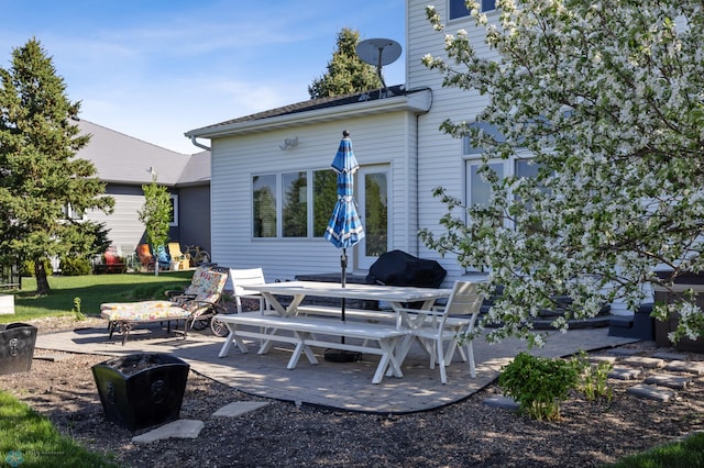 rear view of property featuring a patio area and outdoor dining space