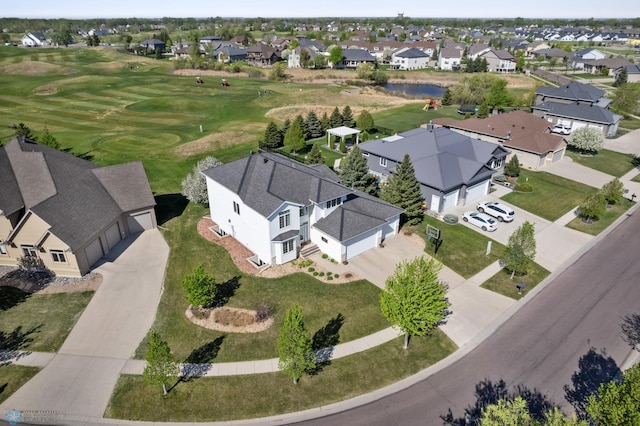 aerial view of residential area featuring a golf club and a nearby body of water