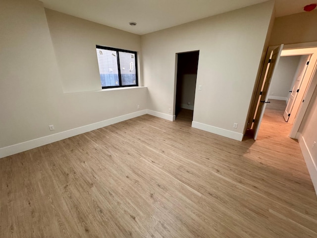 unfurnished bedroom with baseboards and light wood finished floors