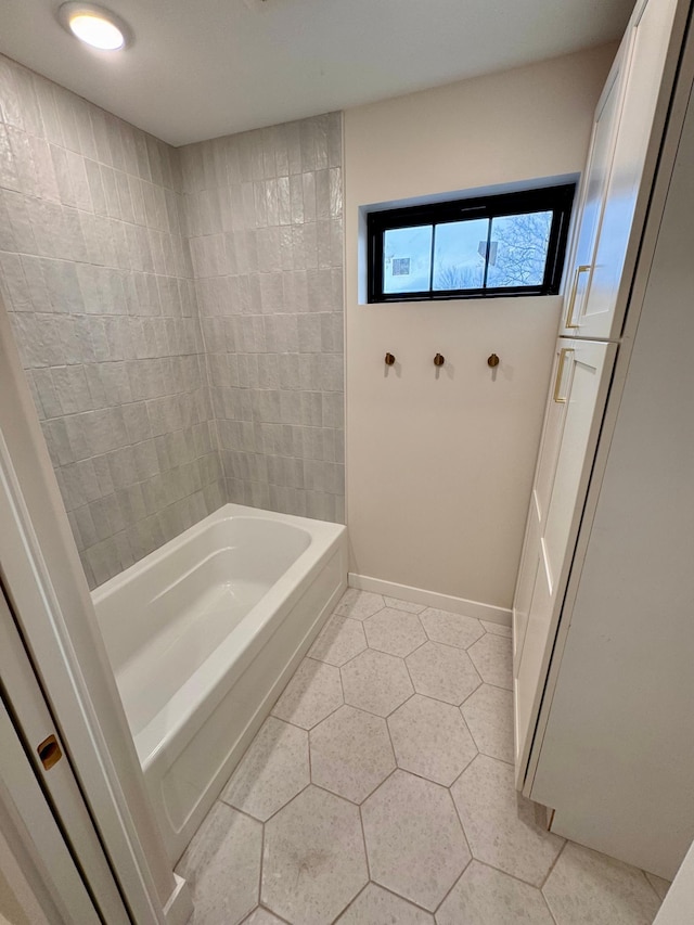 full bathroom with baseboards, tub / shower combination, and tile patterned floors