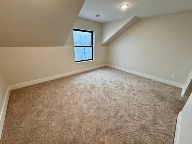 bonus room with baseboards, carpet, and lofted ceiling
