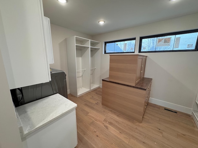 spacious closet featuring light wood-type flooring and visible vents