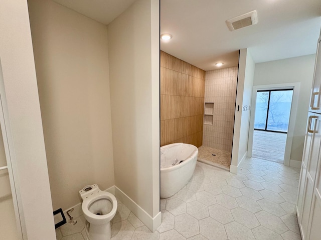 full bathroom featuring a freestanding bath, tile patterned floors, visible vents, a bidet, and tiled shower