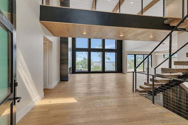 11694 Indian Beach Rd, Spicer, MN 56288 - stairs with expansive windows, hardwood / wood-style flooring, and recessed lighting