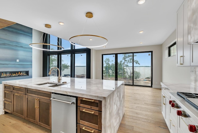 11694 Indian Beach Rd, Spicer, MN 56288 - kitchen with light stone counters, stainless steel appliances, light wood-style floors, and recessed lighting
