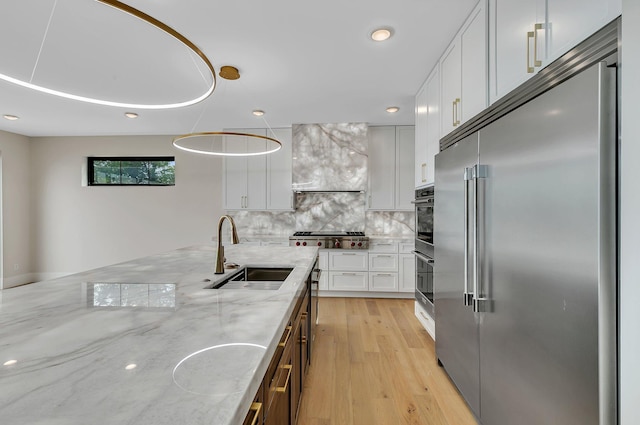 11694 Indian Beach Rd, Spicer, MN 56288 - kitchen with appliances with stainless steel finishes, decorative backsplash, recessed lighting, white cabinets, and light stone countertops