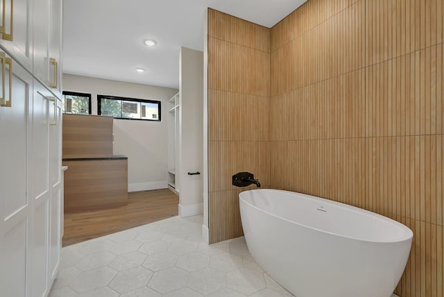 11694 Indian Beach Rd, Spicer, MN 56288 - full bathroom with a soaking tub, tile patterned flooring, and recessed lighting