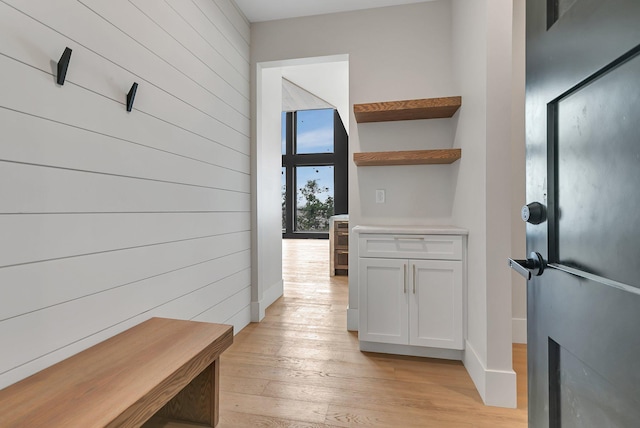 11694 Indian Beach Rd, Spicer, MN 56288 - hallway with light wood-style flooring and wood walls