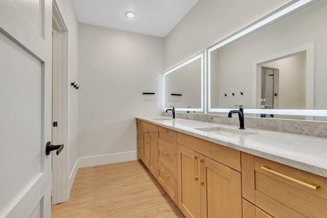 11694 Indian Beach Rd, Spicer, MN 56288 - bathroom featuring double vanity, wood finished floors, and recessed lighting