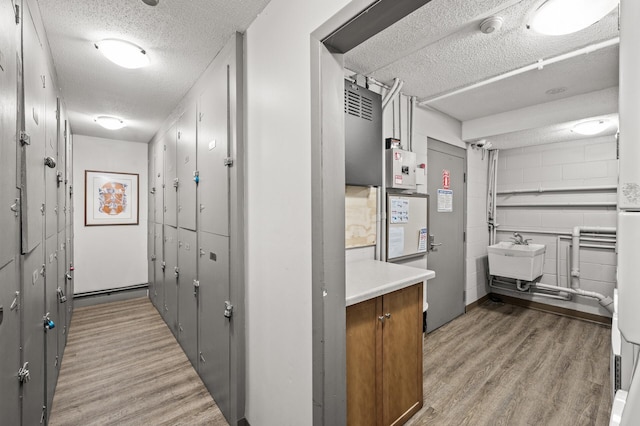 3729 Snelling Ave Unit 203, Minneapolis, MN 55406 - hall featuring light wood-style floors, a textured ceiling, and a sink