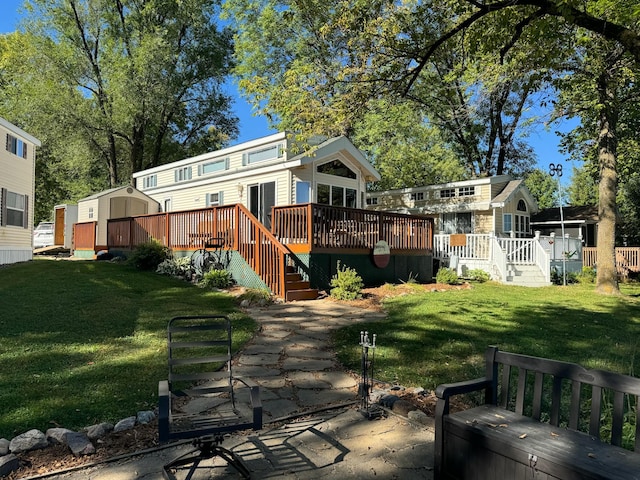 18096 Browns Lake Rd # 17, Richmond, MN 56368 - rear view of house with an outdoor structure, a storage unit, a deck, and a lawn