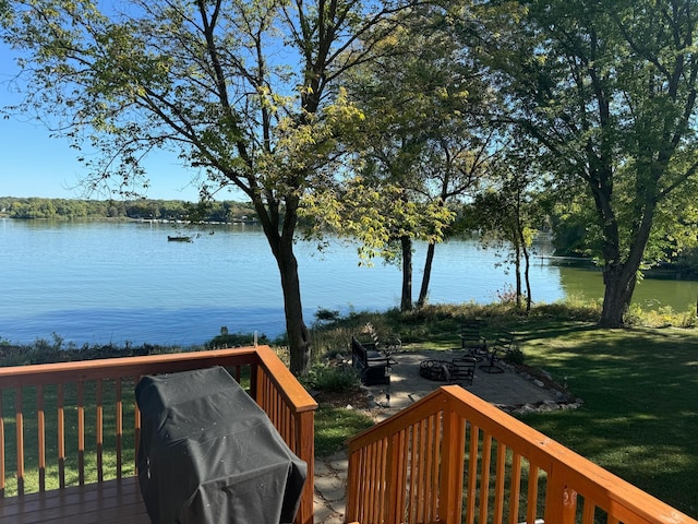 18096 Browns Lake Rd # 17, Richmond, MN 56368 - deck with an outdoor fire pit, grilling area, a water view, and a lawn