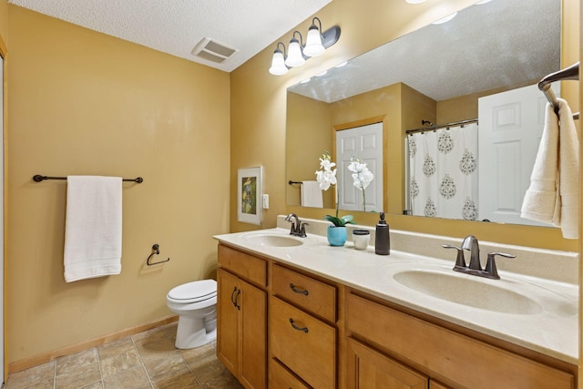 9512 Scott Ln N, Brooklyn Park, MN 55443 - bathroom with double vanity, toilet, baseboards, a textured ceiling, and curtained shower