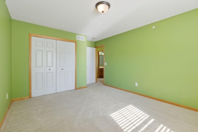 9512 Scott Ln N, Brooklyn Park, MN 55443 - unfurnished bedroom with carpet floors, a textured ceiling, a closet, and baseboards