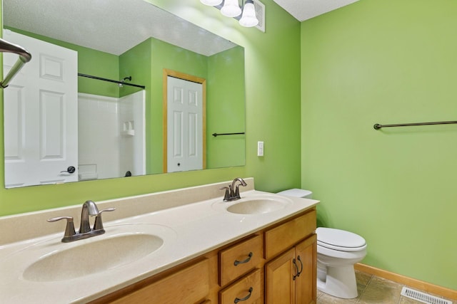9512 Scott Ln N, Brooklyn Park, MN 55443 - bathroom with toilet, double vanity, a shower, tile patterned floors, and baseboards
