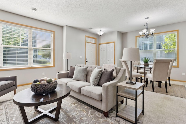 9512 Scott Ln N, Brooklyn Park, MN 55443 - carpeted living area featuring a chandelier, baseboards, and a textured ceiling