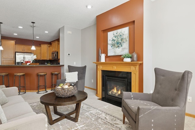 9512 Scott Ln N, Brooklyn Park, MN 55443 - living room with baseboards, a fireplace with flush hearth, recessed lighting, a textured ceiling, and light colored carpet
