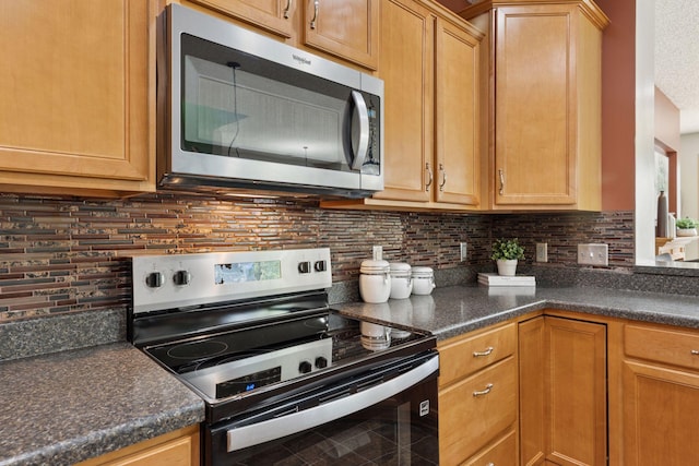 9512 Scott Ln N, Brooklyn Park, MN 55443 - kitchen with appliances with stainless steel finishes, dark countertops, and backsplash