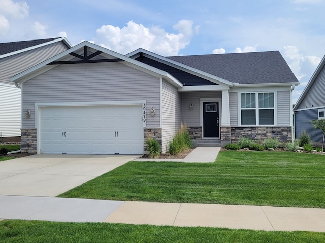 19479 102nd Pl, Corcoran, MN 55374 - craftsman-style house featuring stone siding, concrete driveway, a garage, and a front lawn